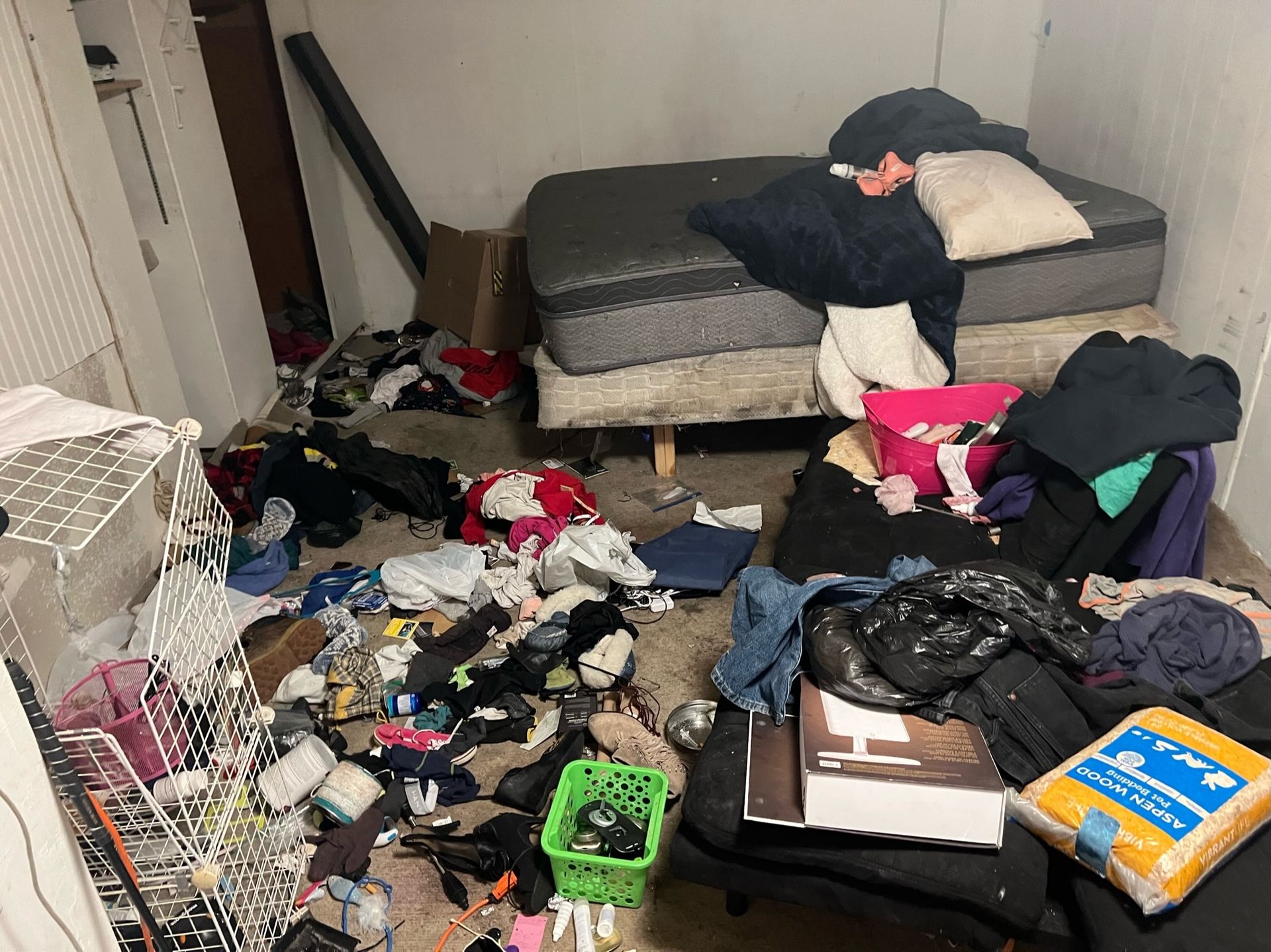 Mattresses and belongings in a room before a cleanout