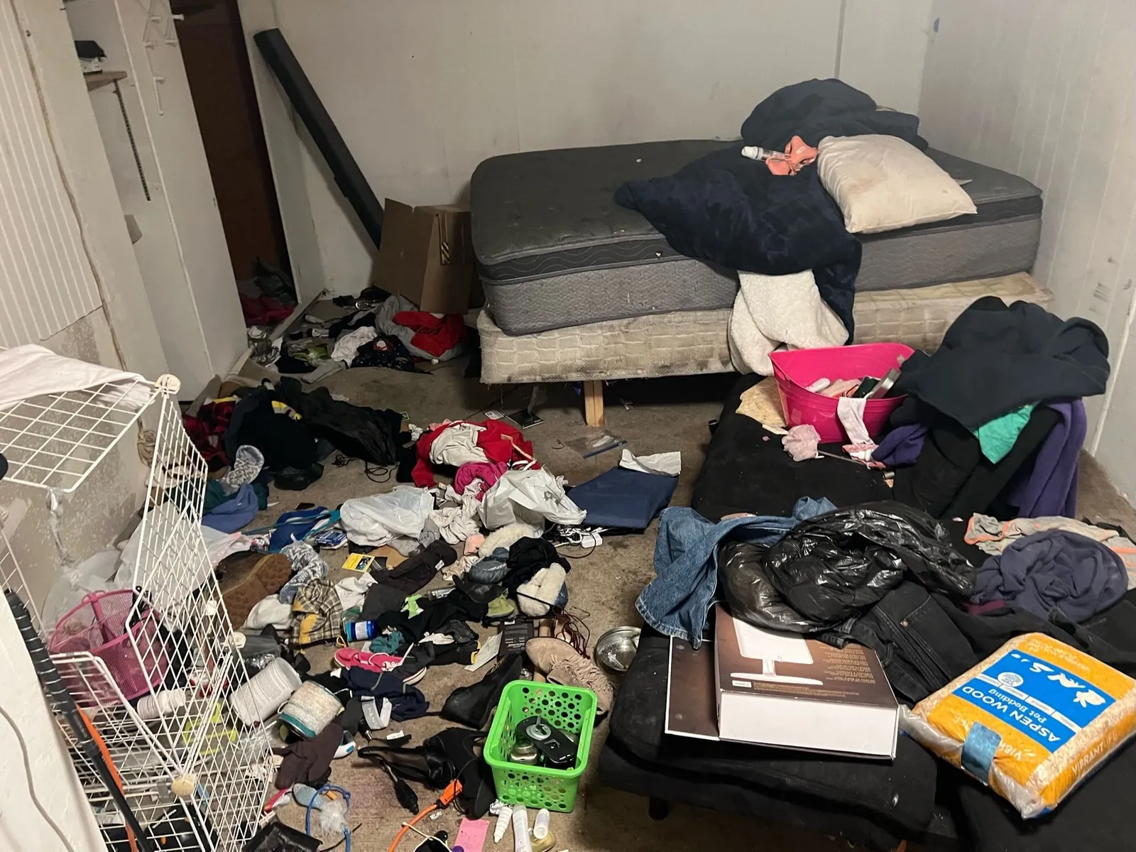 Mattresses and belongings in a room before a cleanout