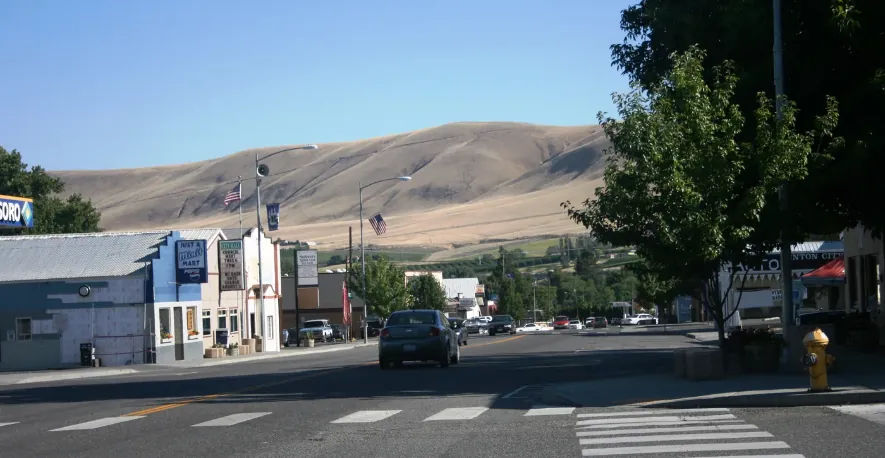 Main street in downtown Benton City, WA with hills in the background
