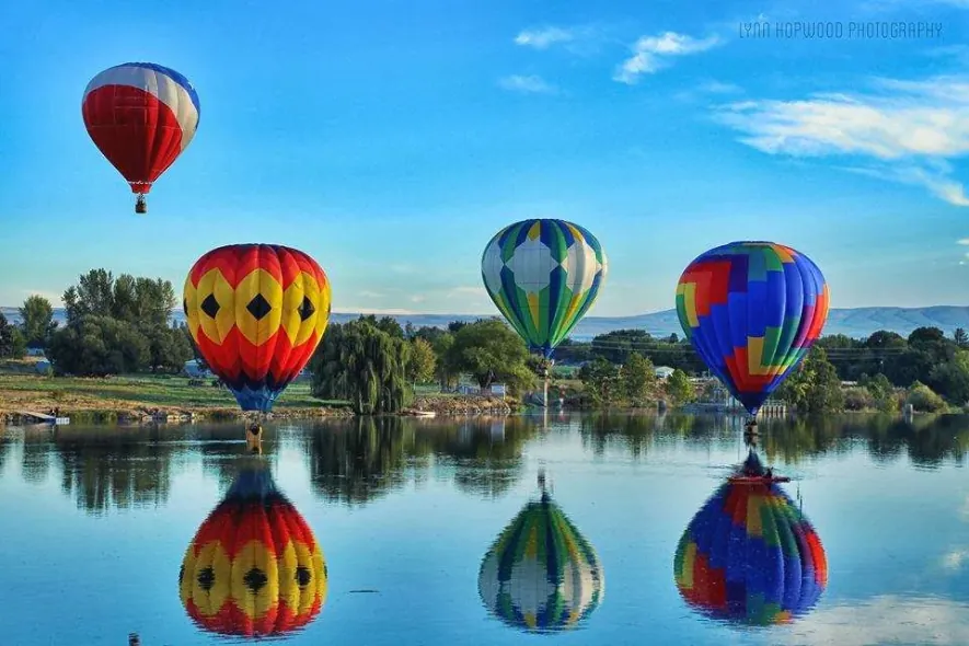 Hot air balloons reflected on the Yakima River during the Prosser balloon rally